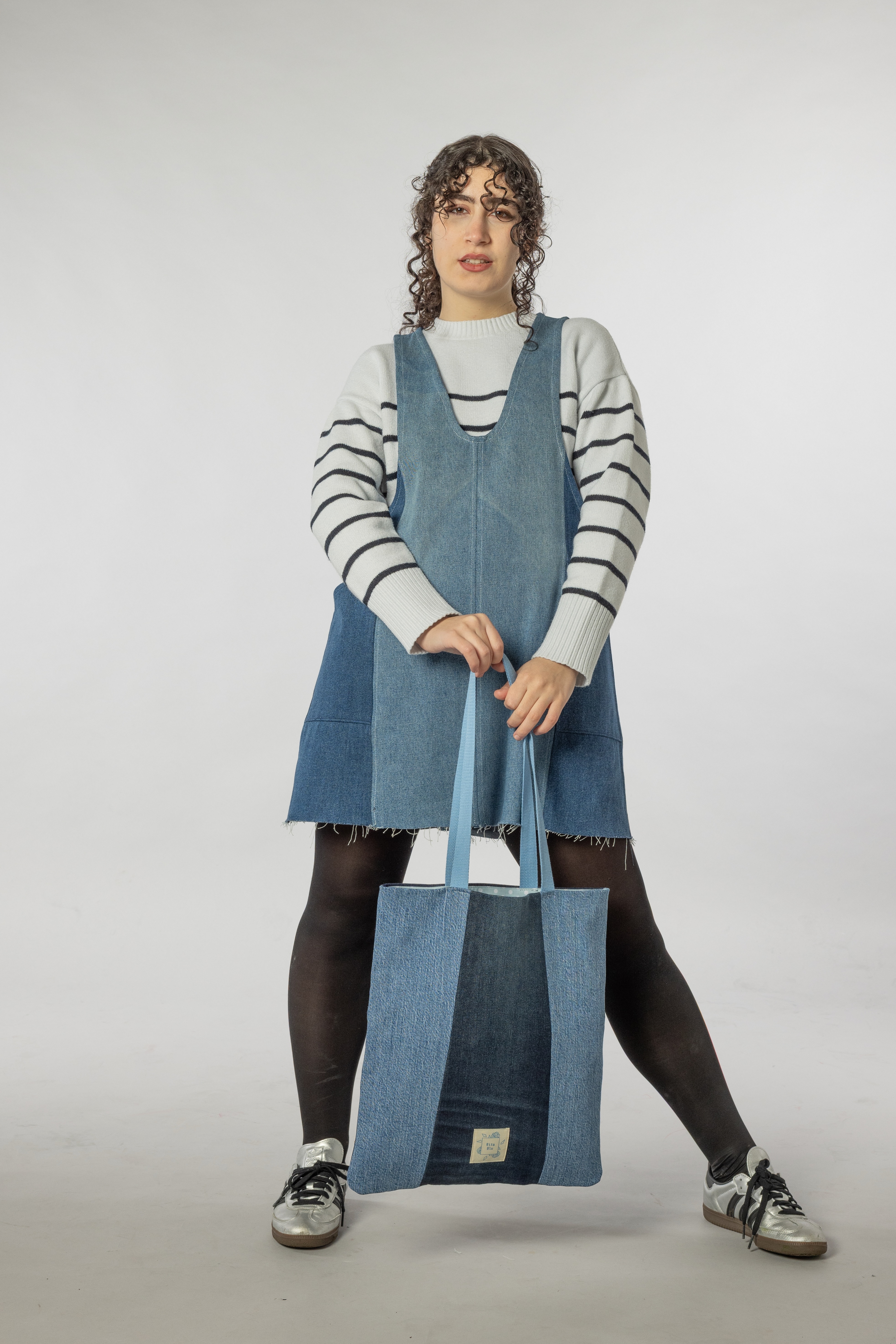 A female model holding the Atlas tote bag.