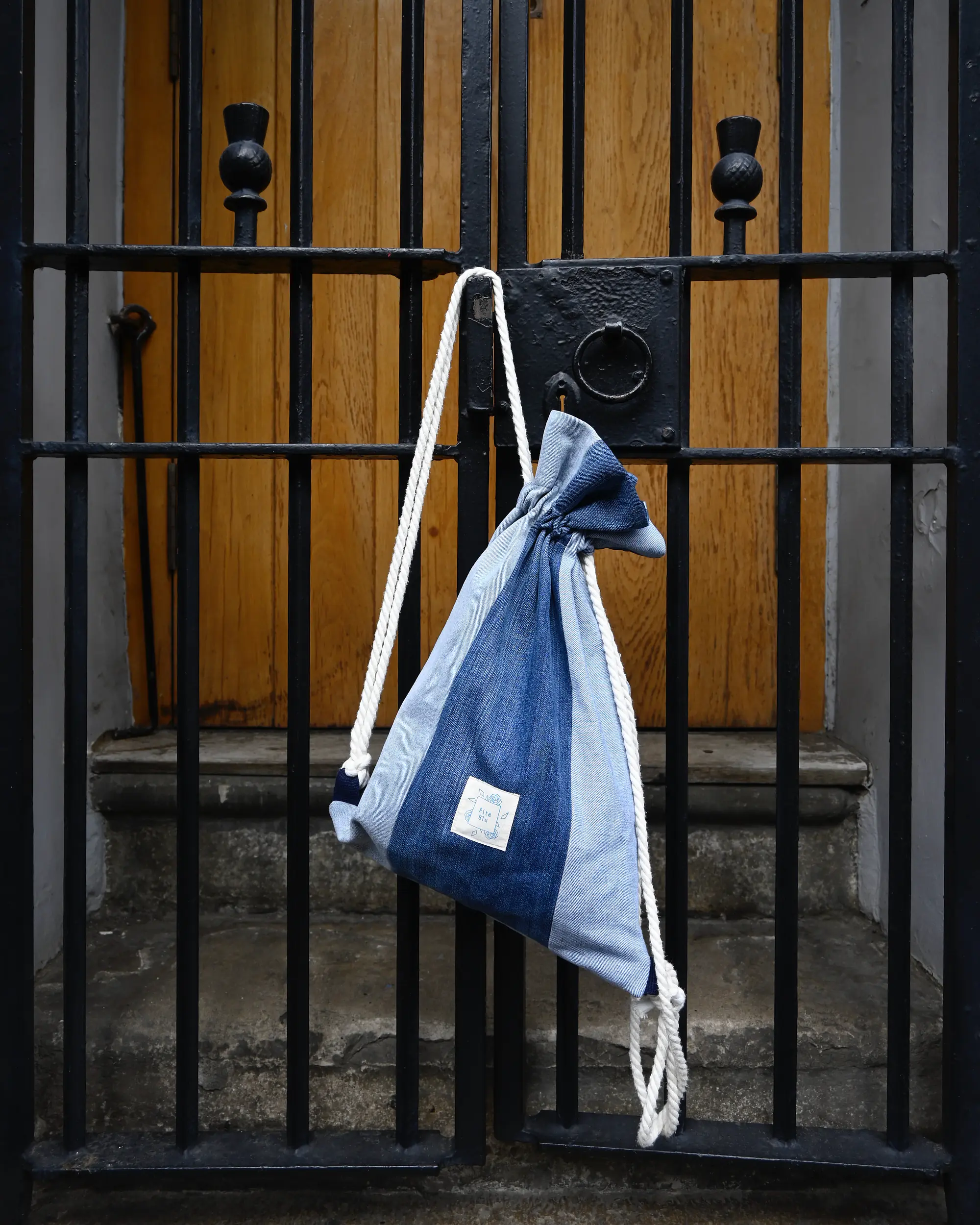 Azuri denim backpack hanging on doorhandle