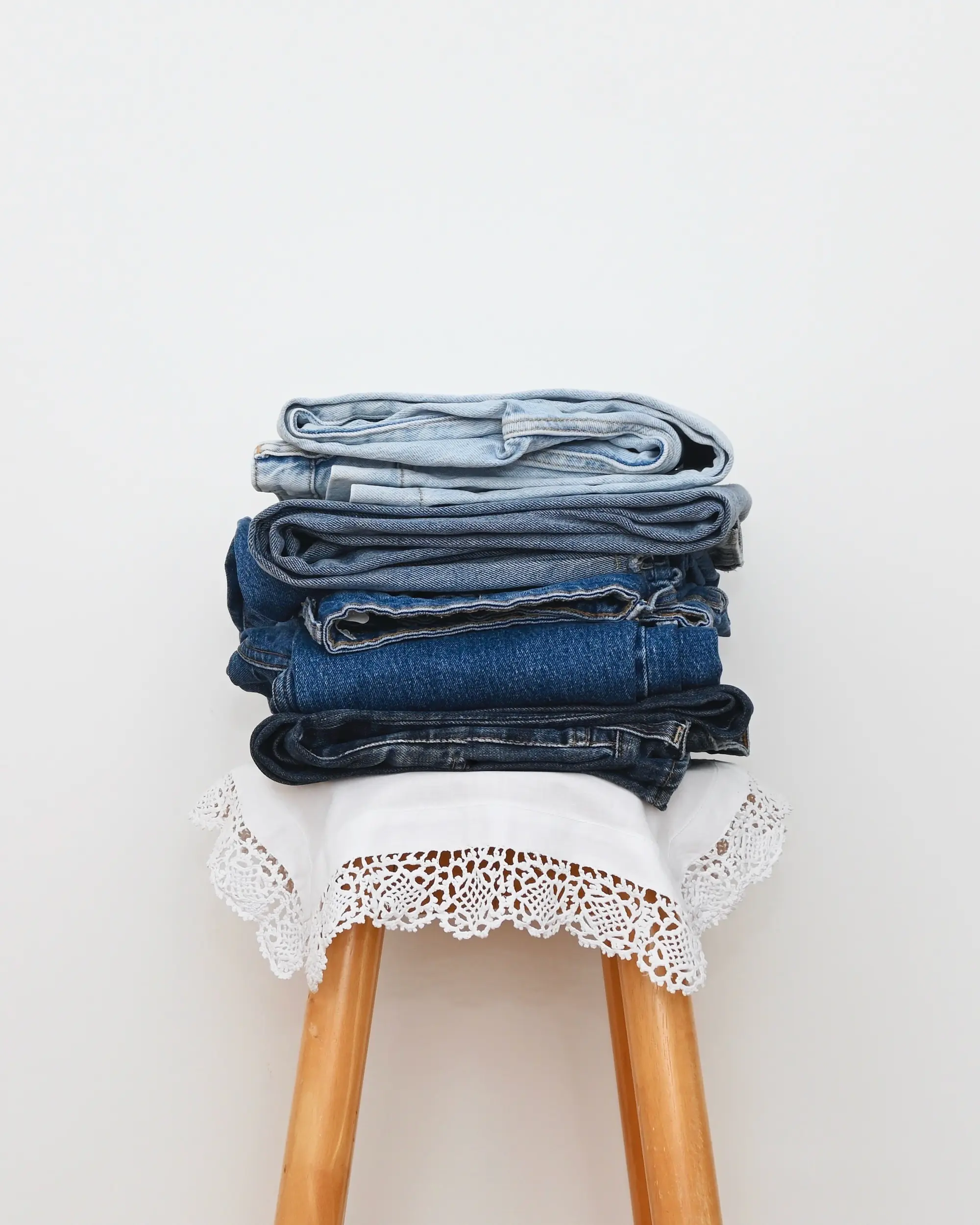 Pile of used jeans on a chair
